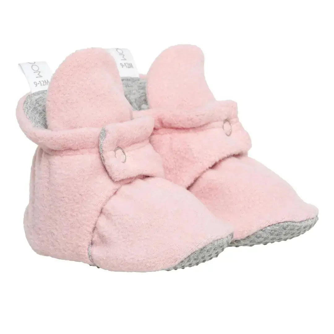 Cute pink baby booties with snap closures, perfect for baby girls