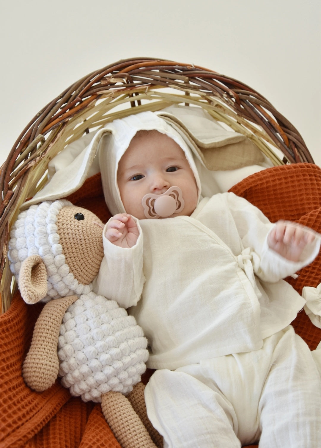 Adorable sage green newborn set with a bunny-themed hat and matching pants