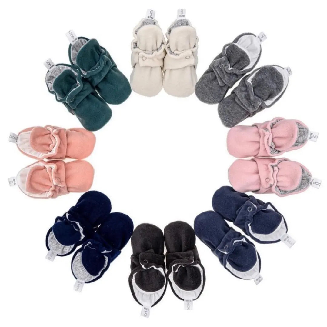 Soft and comfy baby booties in various colors, including white, grey, pink, and navy blue