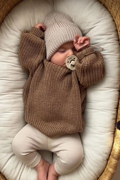 Classic brown baby sweater. Chunky knit design with a timeless appeal. Organic cotton for a cozy and sustainable choice