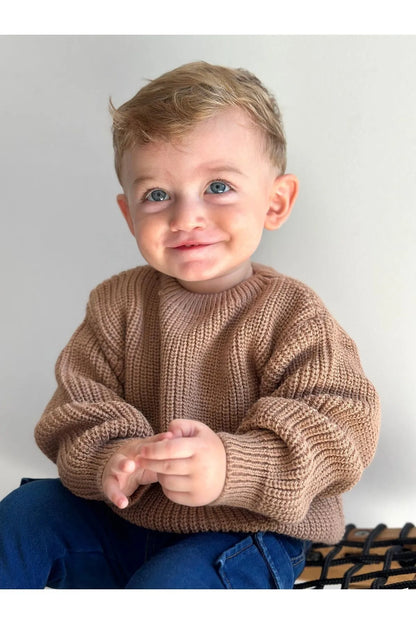 Cozy, latte-hued baby sweater. Soft, chunky knit from 100% organic cotton. Unisex design for warmth and comfort