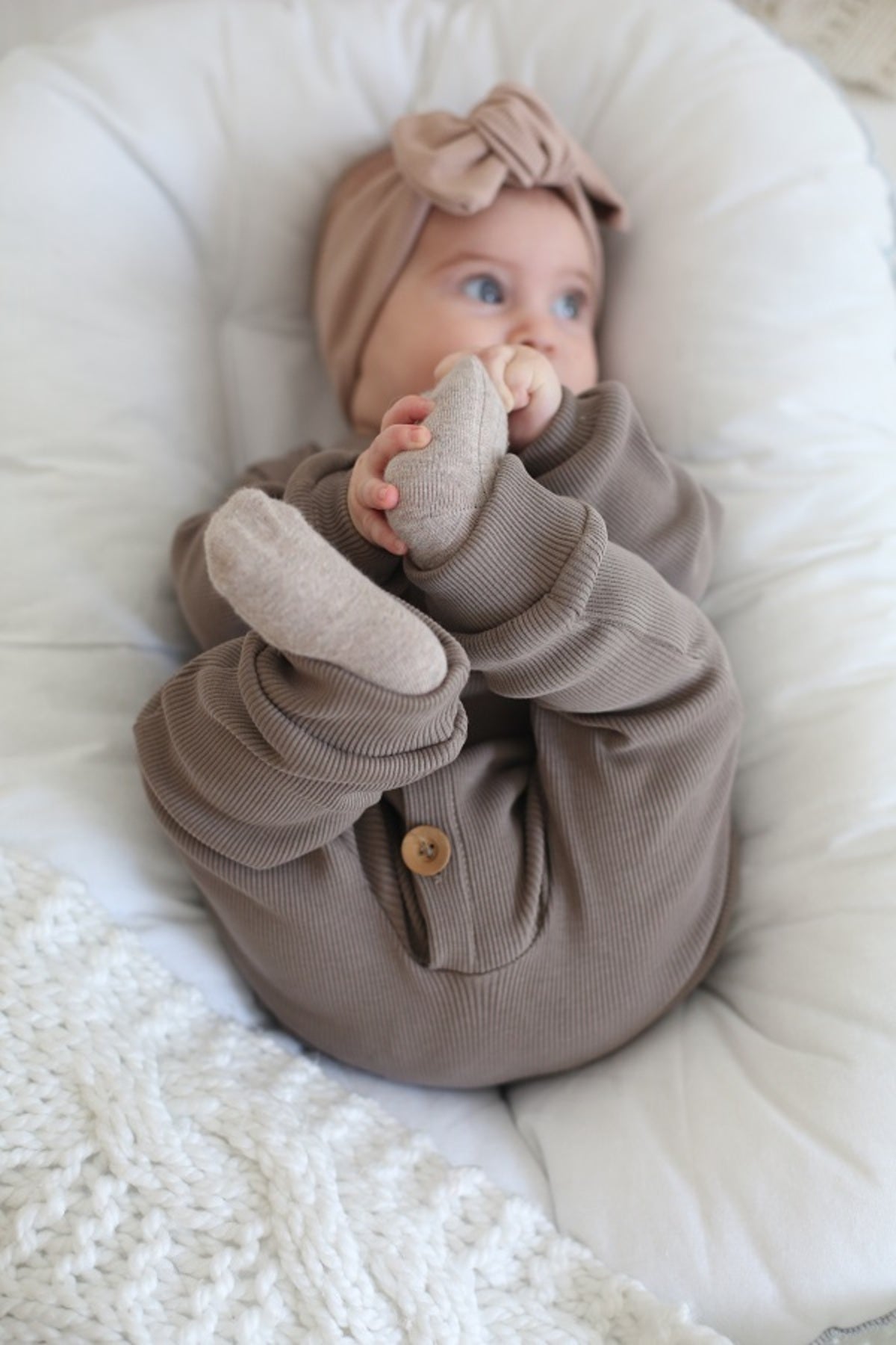 Luxurious mink brown organic cotton sleepsuit. A soft and cozy choice for any baby