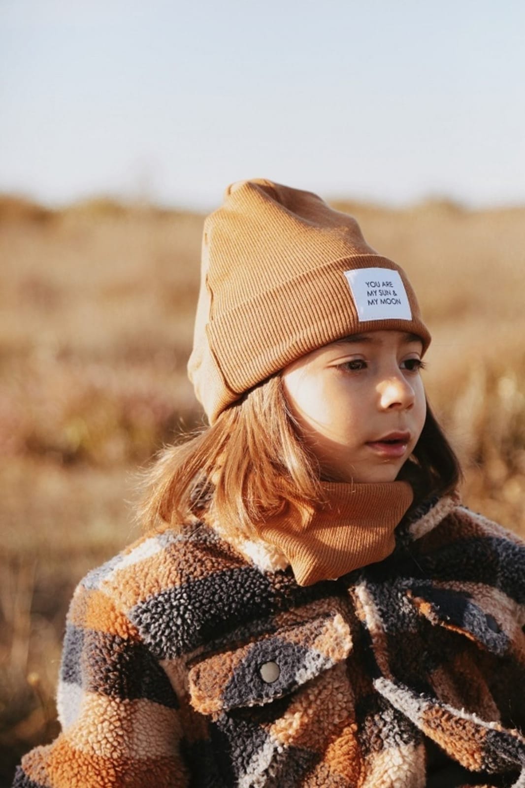 Earthy brown ribbed hat, adding a touch of nature to your outfit. Cozy and warm for chilly days