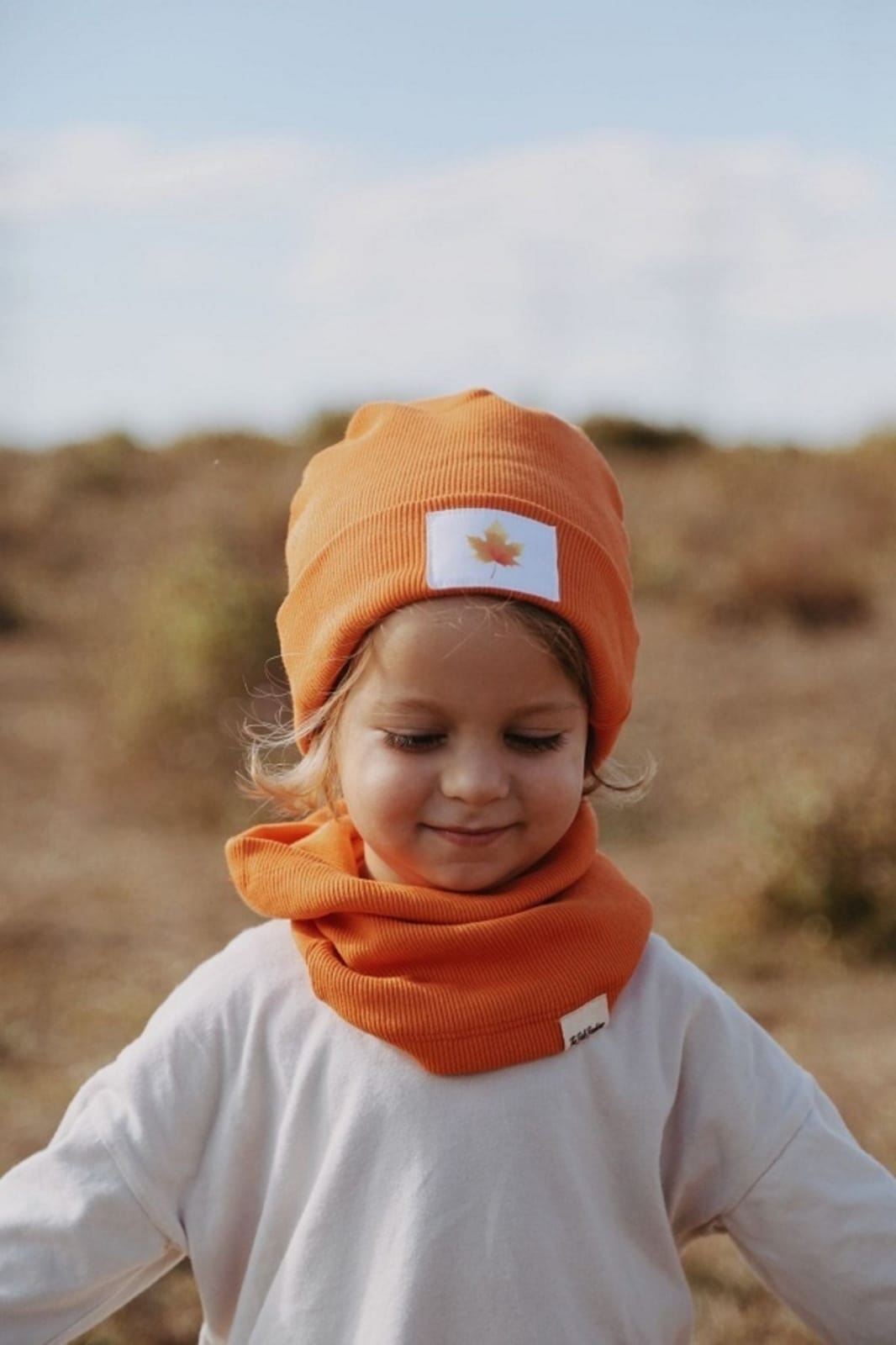 Bright orange ribbed hat, adding a pop of color to your wardrobe. Warm and cozy, perfect for chilly days