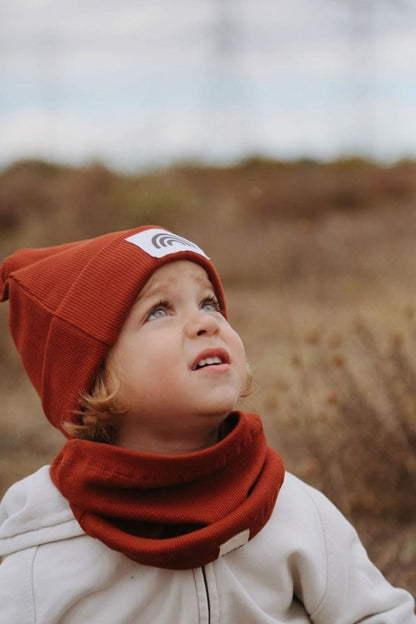 Bold red ribbed hat, making a statement with its vibrant color. Warm and comfortable for winter wear